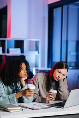 Two businesswoman discuss investment project working and planning strategy with tablet laptop computer