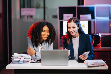 Female discussing new project with Female colleague. Young woman talking with young woman