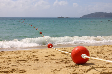 Buoys on the sandy sea beach, safety on the water