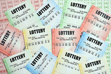 Many lottery tickets on blank bills with numbers for playing lottery close up