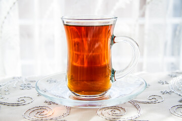 Turkish Tea in Ornate Glass, Beverage on Embroidered Cloth - obrazy, fototapety, plakaty