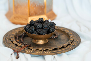 Dates in a vintage bowl with Tasbih , Ramadan background