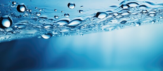 Naklejka na ściany i meble Glistening Water Drops Create a Serene Atmosphere on a Vibrant Blue Background