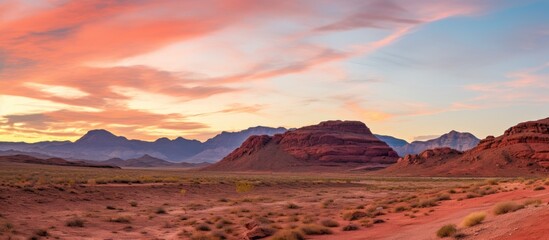 Vibrant Red Rock Formation Amidst Desert Wilderness Landscape Under Blue Sky