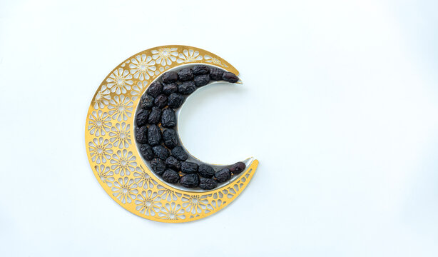 Iftar creative photo beautiful dates in shape of crescent moon isolated on white background with copy space for greeting text, Ramadan Kareem 2024 poster