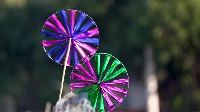 Pinwheel windmills handmade of colorful paper sold by street vendors in india at tourist spots and in fetes, fairs and melas as a cheap and fun toy for children