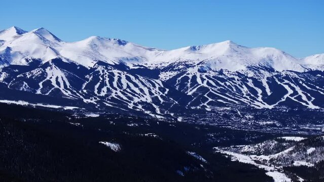 Sunny winter morning blue sky Breckenridge Ski resort town Vail Epic Ikon Pass aerial drone landscape ski trail runs Summit County Tiger Swan Mountain road Tenmile peaks Rocky Mountains circle right