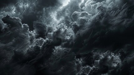Fototapeta premium The sky is full of dark clouds in bad weather before a big storm rain. Light emission from the Edge of clouds. Zoom the surface of a Black haze at close range.