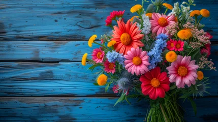 Foto op Plexiglas Colorful bouquet of wildflowers on a blue wooden background © Виктория Дутко