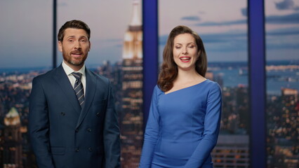 Positive news readers beginning live tv newscast in channel studio close up.