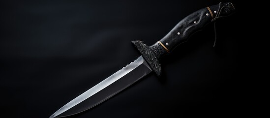 Dark and Mysterious: Sharp Blade of Knife Against Black Background
