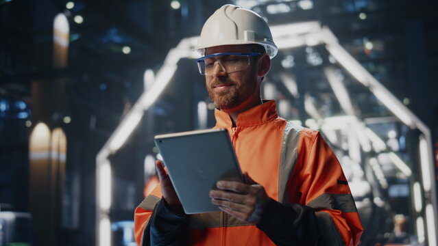 Smiling engineer making inspection production workshop with pad computer closeup