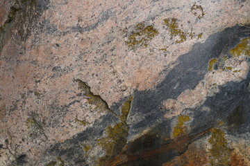 Obraz premium Close-up of beige-pink cobblestone texture with gray veins and greenish cracks