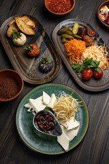 Assortment of appetizers on a dark wooden background. Top view