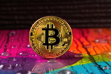 Bitcoin logo on colorful rainbow background