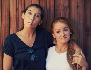 Portrait, funny face and woman friends on wooden background together for bonding or relationship....