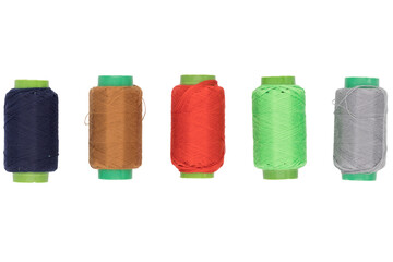 Colored spools of thread on a white background
