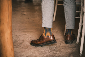 Brown shoes worn by men with striped socks