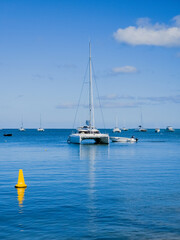 Serenity on the Seas: Sailboat Anchored in Calm Blue Waters