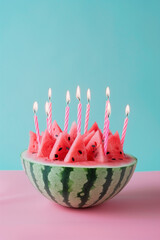 Watermelon cake with candles on blue and pink pastel background.
