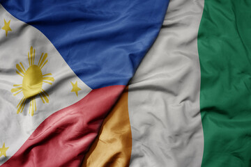 big waving national colorful flag of cote divoire and national flag of philippines.