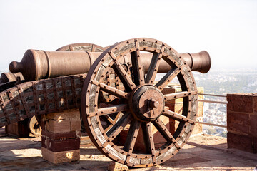 Massive iron cannon with wheels placed on the walls of mehrangarh amer fort in jaipur jodhpur...
