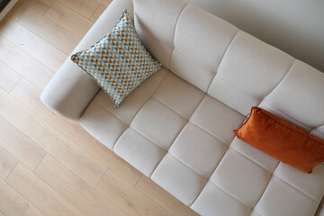 modern sofa with pillows in living room at home