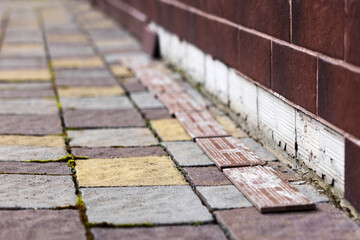 Foundation Sheathing Problem Outdoor. Facing Tiles Foundation Downfall due to Moisture. Protective Tiling Coating. Repair and Construction concept.