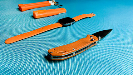 various sporting goods in orange color against blue background