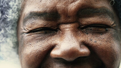 One peaceful wrinkled South American black woman closing eyes in meditation in macro closeup,...