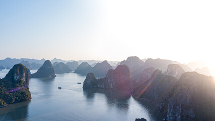 Aerial view floating fishing village and rock island, Halong Bay, Vietnam, Southeast Asia. UNESCO World Heritage Site. Junk boat cruise to Ha Long Bay. Popular landmark, famous destination of Vietnam - obrazy, fototapety, plakaty