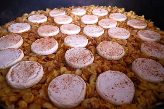 Giant fresh tartiflette, made with Roblochon cheese, potatoes and ham, a speciality in the French Alpes, Saint Gervais, Haute-Savoie, France