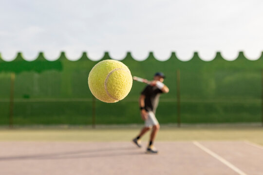 Tennis player hitting ball with backhand stroke
