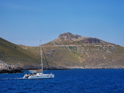 Sailboat off the coast and Medieval Castle of Pandeli, Leros Island, Dodecanese