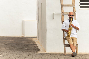 Man playing saxophone outdoors on International Jazz Day