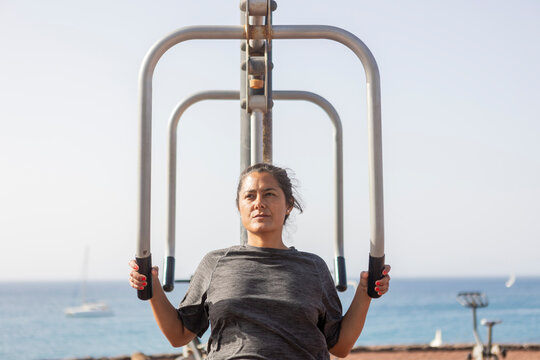 Woman Training at Scenic Seaside Outdoor Gym