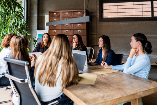 All-Women Team in Meeting at Modern Workspace