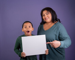Mother and son with a blank sign