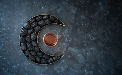 Ramadan Kareem Iftar greeting banner image, flatly image of black tea with dates on a crescent moon...