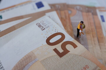 Lovers in love, pair of young people on European money, Euro. Concept of expensive life.