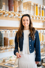 Young Caucasian woman in unpackaged store. Plastic-free shopping in a German zero waste store.