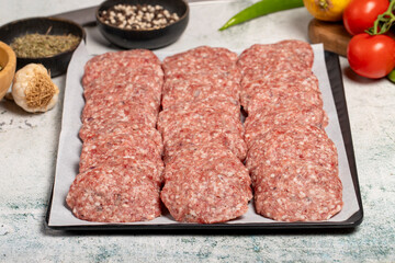 Beef meatballs. Butcher products. Raw beef meatballs on stone background