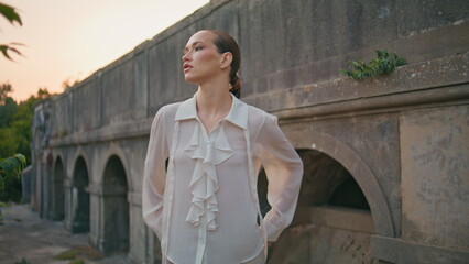 Girl tourist enjoy stroll at stone ancient fortress. Beautiful woman standing 