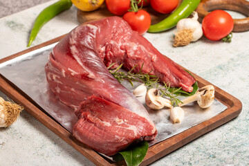 Beef Tenderloin. Butcher products. Raw beef tenderloin on stone background