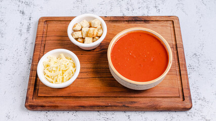Tomato soup bowl with crackers and cheese