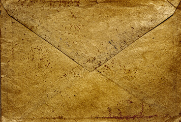 front view closeup of blank old aged closed letter paper envelope with torn edges from 1900