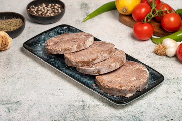 Roast beef. Butcher products. Roasting sliced beef on stone background