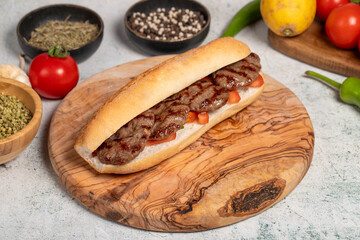 Turkish meatballs on a serving board. Meatballs in bread prepared with tomatoes, peppers and meatballs. Local name ekmek arası köfte