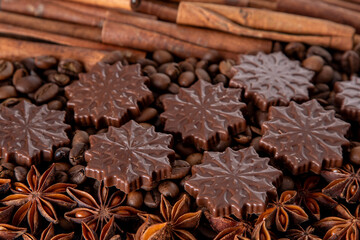 Food background. Coffee beans, cinnamon sticks, anise stars and chocolate candies top view.