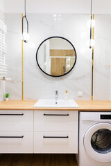 White modern bathroom vanity with washing machine and mirror